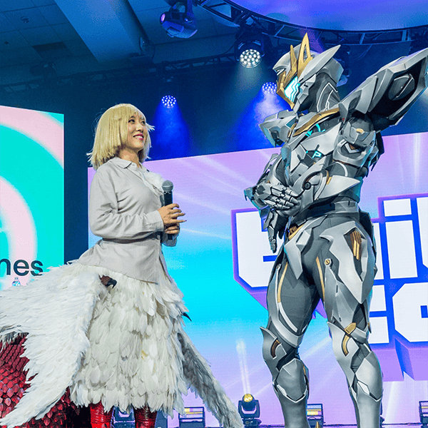 Two people in costumes, on stage