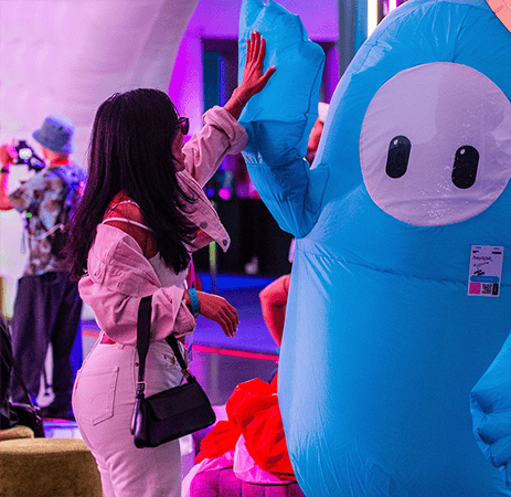Woman hi-fiving a mascot